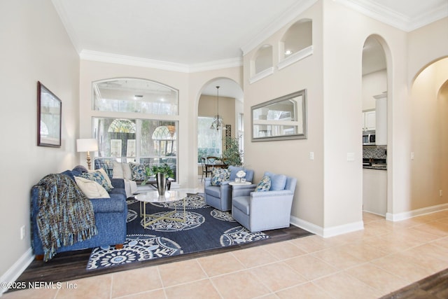 living room with light tile patterned floors, baseboards, and ornamental molding