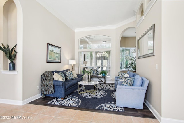 tiled living room with baseboards and crown molding