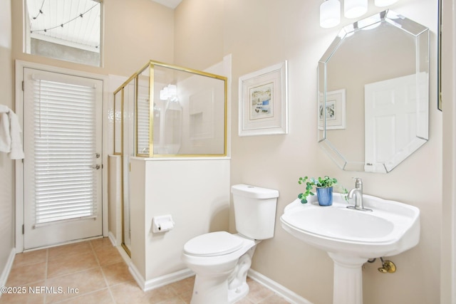 full bath featuring tile patterned floors, baseboards, toilet, and a shower stall