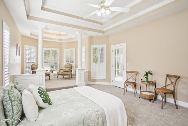 bedroom with a raised ceiling, carpet flooring, and ornate columns