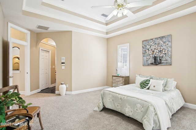 bedroom featuring baseboards, a tray ceiling, carpet floors, and visible vents