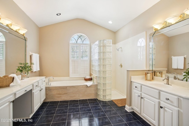 bathroom featuring a sink, walk in shower, a bath, and tile patterned floors