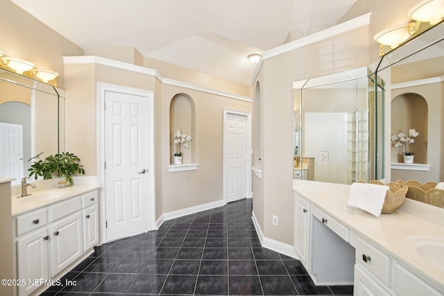 bathroom with a sink, lofted ceiling, two vanities, and tile patterned flooring