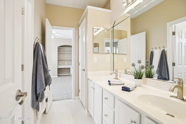 bathroom featuring tile patterned flooring, double vanity, and a sink