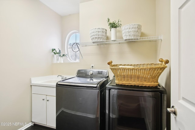 clothes washing area featuring a sink and washer and clothes dryer