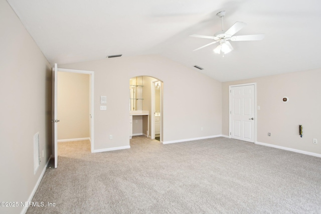 unfurnished bedroom featuring visible vents, baseboards, lofted ceiling, and carpet floors