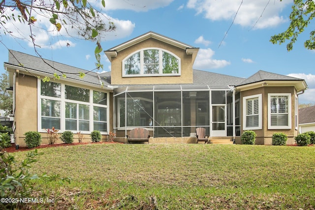 back of house with a yard, a sunroom, and stucco siding