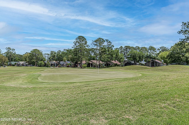 view of community featuring a yard and golf course view