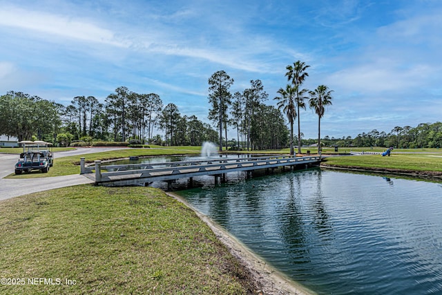 view of dock featuring a yard and a water view