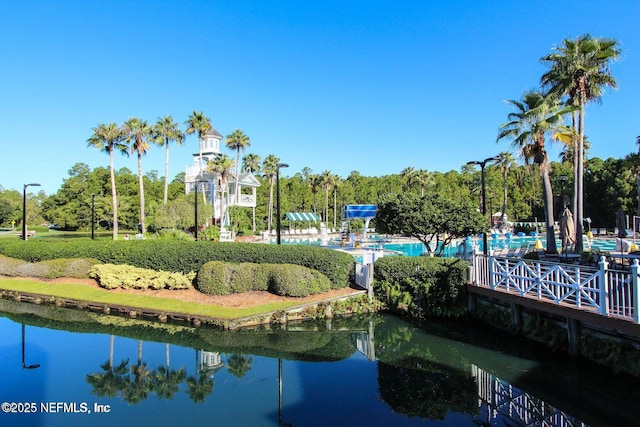 view of property's community featuring a swimming pool and a water view