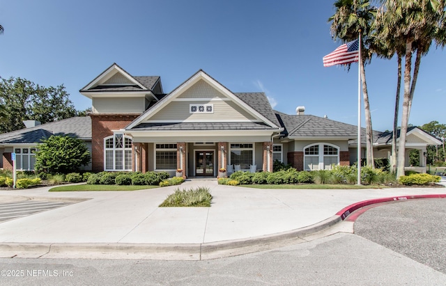 view of front of house featuring french doors and brick siding