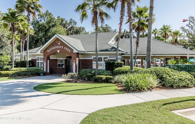 view of front of house featuring brick siding and concrete driveway