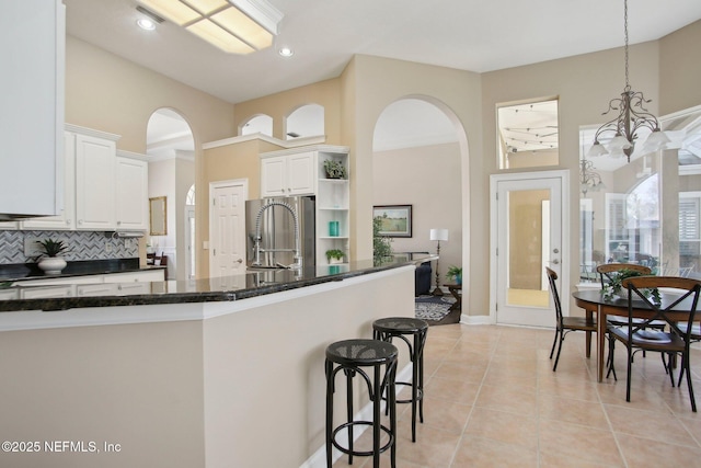 kitchen featuring a sink, open shelves, white cabinetry, and light tile patterned floors