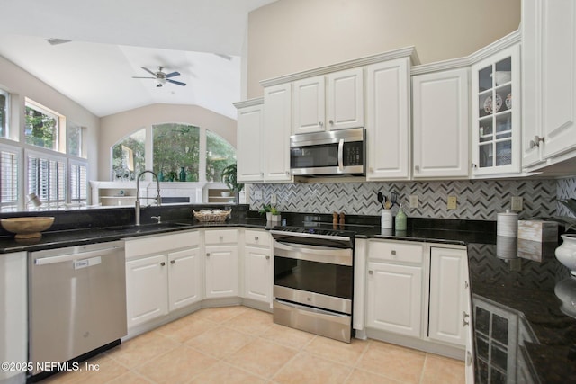 kitchen featuring a sink, tasteful backsplash, appliances with stainless steel finishes, and vaulted ceiling