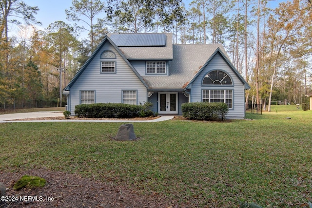 view of front of house with french doors and a front lawn