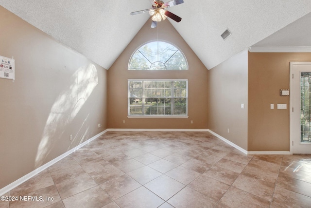 unfurnished room featuring a textured ceiling, vaulted ceiling, ceiling fan, and light tile patterned flooring