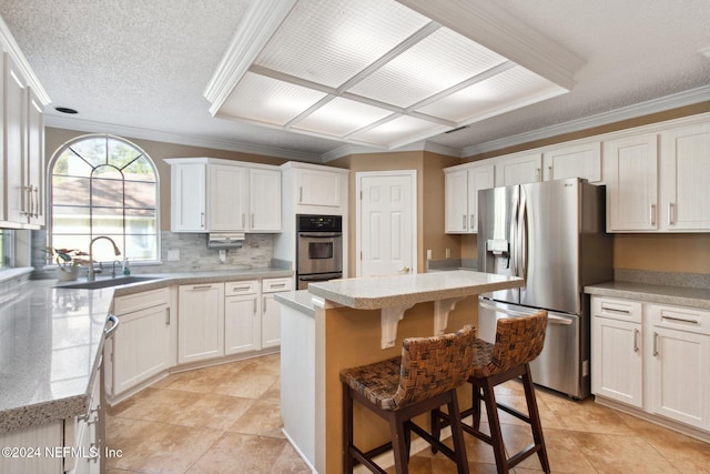 kitchen with a center island, white cabinets, and appliances with stainless steel finishes