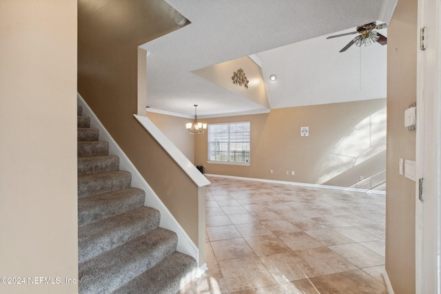 stairs featuring a textured ceiling, ceiling fan with notable chandelier, and tile patterned floors