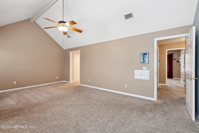 carpeted spare room with vaulted ceiling with beams and ceiling fan