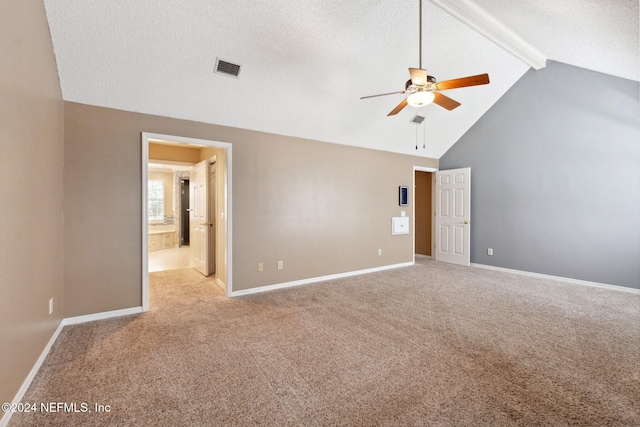 empty room with light carpet, beam ceiling, a textured ceiling, and ceiling fan