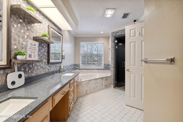 bathroom with vanity, tile patterned floors, ornamental molding, shower with separate bathtub, and a textured ceiling