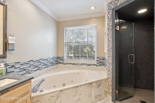 bathroom featuring vanity, independent shower and bath, a textured ceiling, and ornamental molding