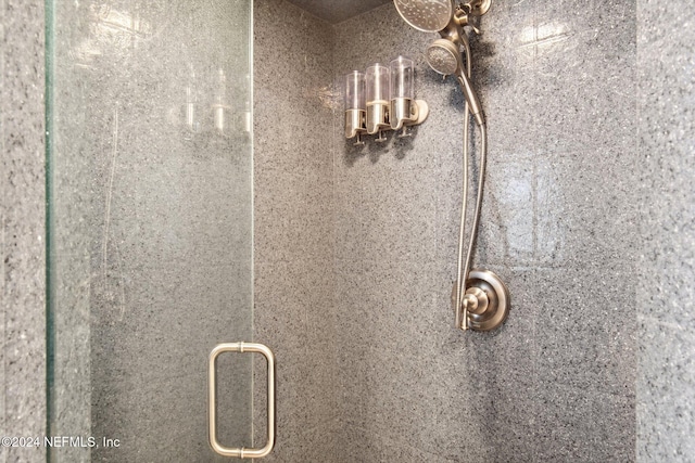 details featuring a shower with shower door