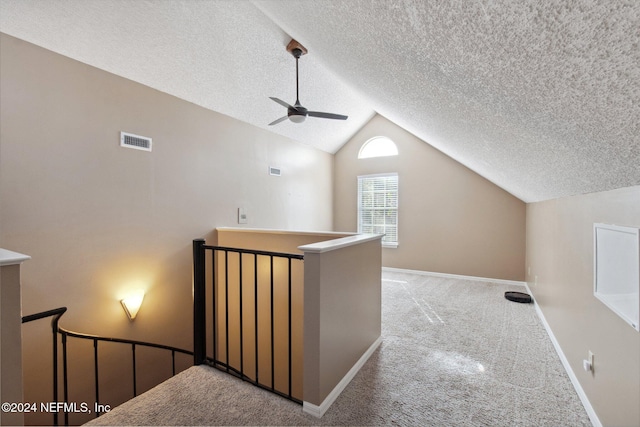 bonus room with a textured ceiling, ceiling fan, carpet, and vaulted ceiling