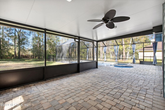 unfurnished sunroom with ceiling fan