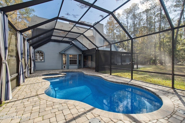 view of pool with a lanai, an in ground hot tub, and a patio