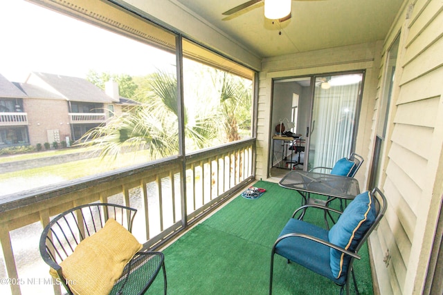 sunroom featuring ceiling fan