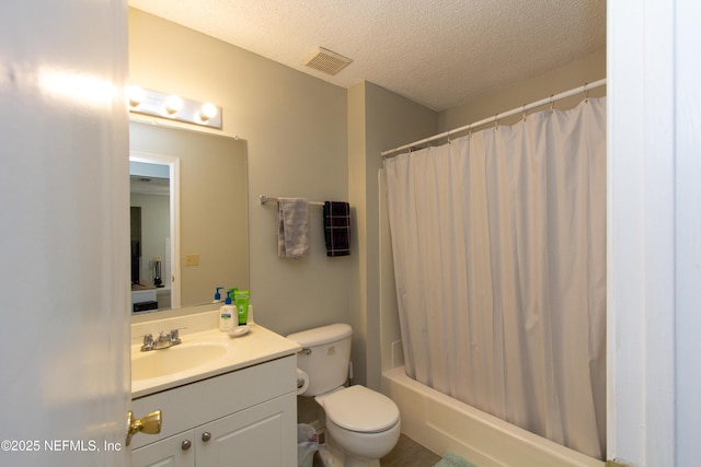 full bathroom featuring shower / bath combo, vanity, a textured ceiling, and toilet