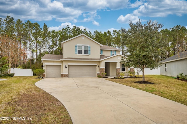 view of front of property featuring a garage and a front yard