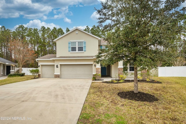 view of front of house featuring a garage and a front yard