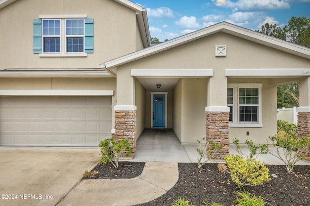 view of exterior entry featuring a garage