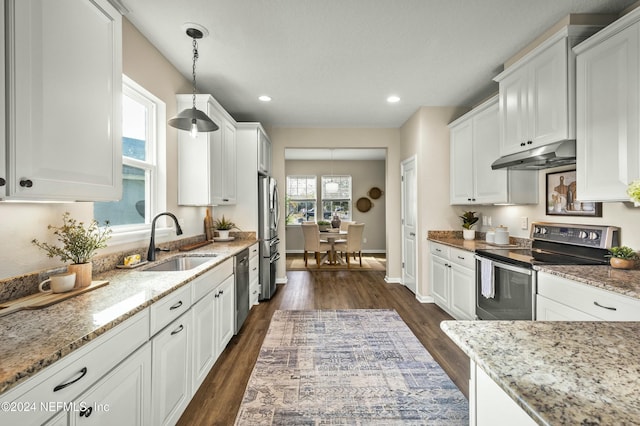 kitchen with decorative light fixtures, white cabinetry, sink, and appliances with stainless steel finishes