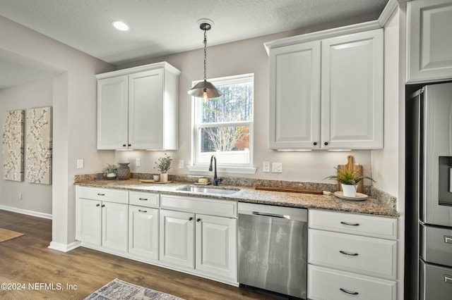 kitchen with white cabinetry, sink, dark hardwood / wood-style floors, and appliances with stainless steel finishes