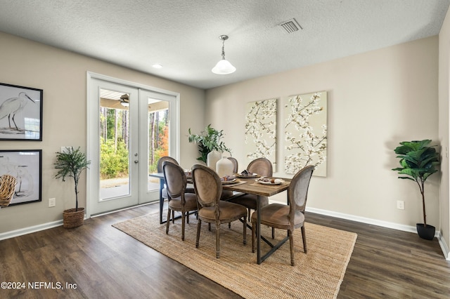 dining room featuring dark hardwood / wood-style floors and a textured ceiling