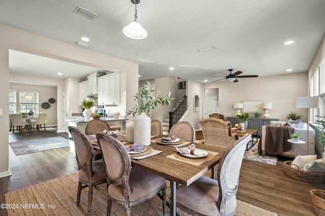 dining area with a textured ceiling, dark hardwood / wood-style flooring, and ceiling fan