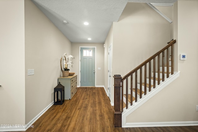 entryway featuring a textured ceiling and dark hardwood / wood-style floors