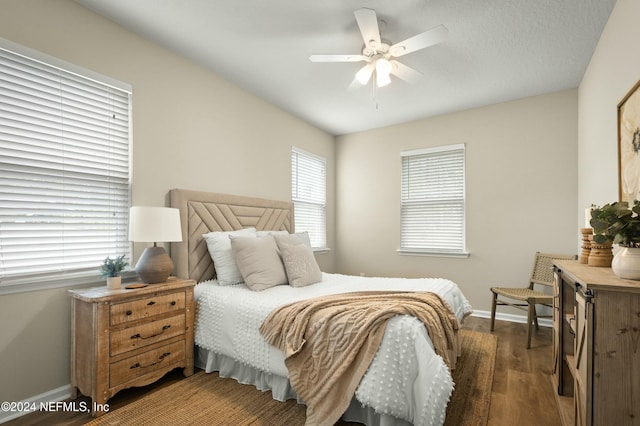 bedroom featuring dark hardwood / wood-style flooring and ceiling fan