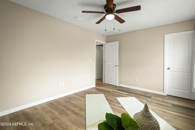 unfurnished bedroom featuring ceiling fan and hardwood / wood-style floors