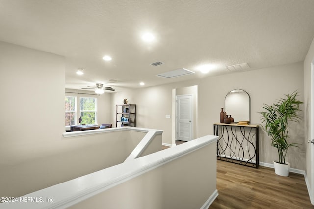 corridor featuring hardwood / wood-style floors and a textured ceiling