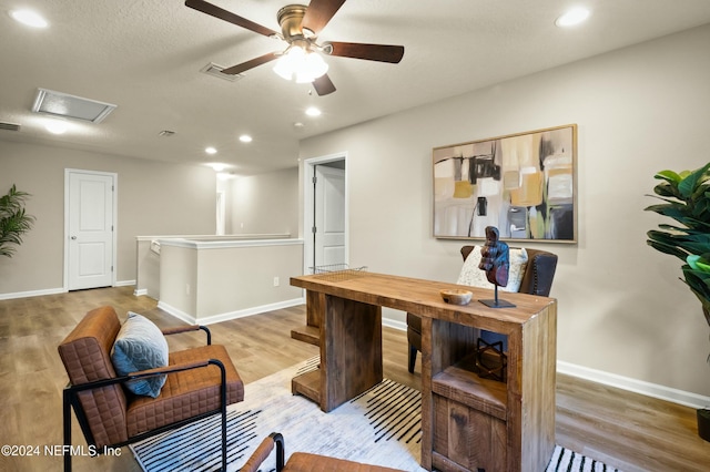 office space with hardwood / wood-style flooring, ceiling fan, and a textured ceiling