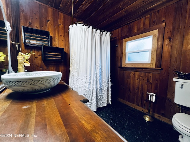 bathroom featuring hardwood / wood-style flooring, toilet, wooden walls, and wood ceiling