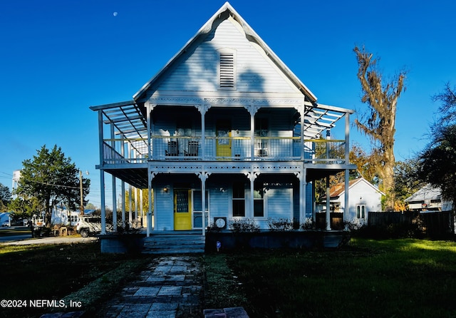 view of front of home with a porch and a front yard