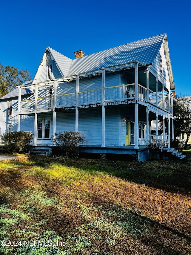 back of house with a lawn