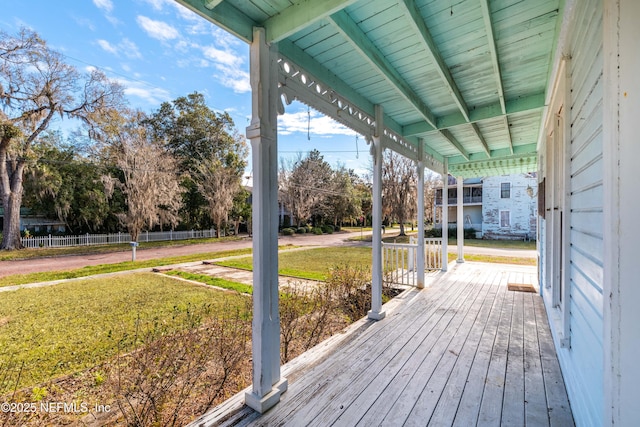 wooden deck featuring a yard