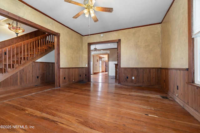 unfurnished room featuring hardwood / wood-style flooring, ornamental molding, and ceiling fan