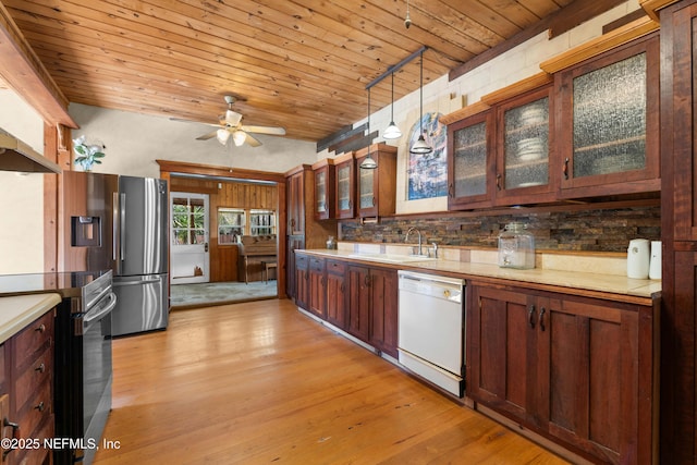 kitchen featuring pendant lighting, sink, light hardwood / wood-style floors, stainless steel appliances, and wooden ceiling